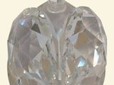 a clear glass heart shaped object on a white background