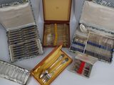 a lot of silverware in a case on a table