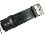 a close up of a watch with a leather strap