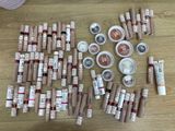 a lot of lipsticks and lip bales on the table