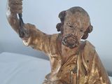 a statue of a man holding a bird in his hand