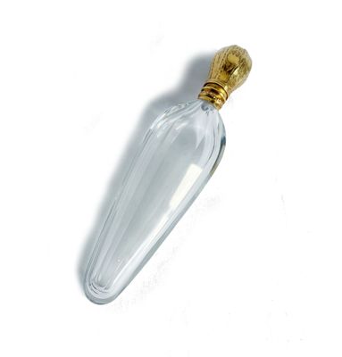 a clear glass bottle with a gold top