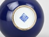 blue and white porcelain vase with gold trim and a blue and white design