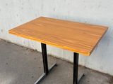 an image of a wooden table with black legs
