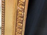an image of a gold framed mirror with a black background