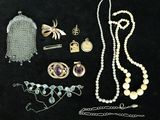 some of the jewelry is laid out on a black surface
