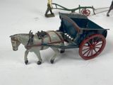 a toy horse pulling a carriage with a man in the back