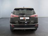 the back end of a black toyota rav parked in a room