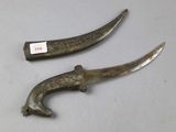 two old knives that have been left on the table