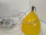 a yellow lamp that is sitting on a counter