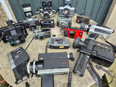 a lot of cameras that are sitting on a table