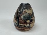 a small vase with a painting on it sitting on a table