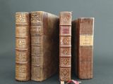 three old books that are sitting on a table