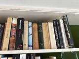 many books that are on a shelf in the room