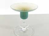 a glass with a yellow substance in it sitting on a table