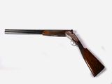 a close up of a rifle on a white surface with a white background
