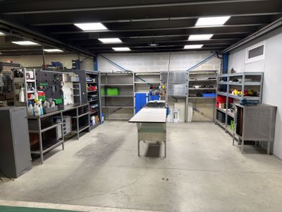 an image of a room with a lot of shelves and a table