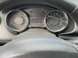 dashboard view of a car with a steering wheel and dashboard gauges