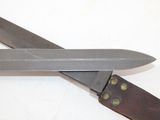 two knives that are laying side by side on a table