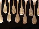 a lot of spoons that are hanging from the ceiling