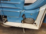 a blue and white scooter parked in a garage