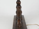 an antique wooden table lamp with a wooden base and a brass plate on the base