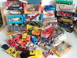 a lot of toy cars that are sitting on a table