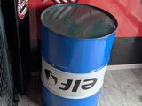 a blue barrel sitting in front of a red wall