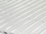 a close up of a white tile with a white background