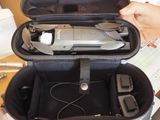 a person holding a case with a remote control inside of it