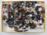 a box full of assorted buttons on a table