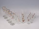 several glasses are lined up in a row on a white surface