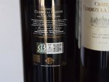two bottles of wine sitting next to each other on a table