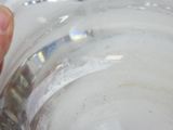 a person holding a glass with a liquid inside of it