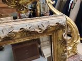 a mirror that is sitting on the floor in a store