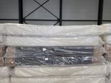 a large pile of mattresses sitting in a warehouse