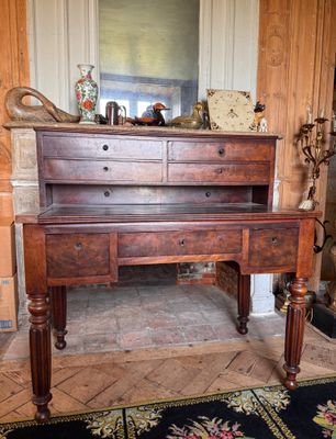 a wooden desk with two drawers on top of it