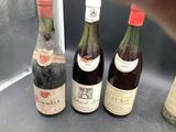 several bottles of wine are lined up on a counter