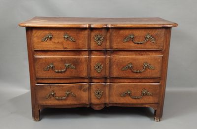 a wooden chest of drawers with ornate handles and drawers