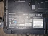 a close up of a laptop with a battery attached to it
