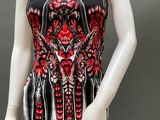 a mannequin wearing a black and red dress with red flowers on it