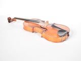 a violin that is sitting on a white surface