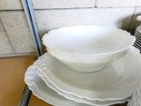 a stack of plates and bowls sitting on a table
