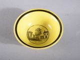 yellow and black bowl with a picture of a house on it