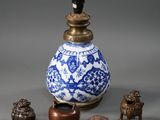 a blue and white vase sitting next to other small objects