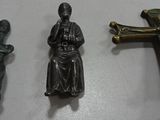 three crosses, a crucifix, and a statue of jesus on a table