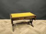 a wooden desk with a yellow top on a wooden floor