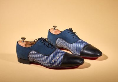 the shoes are blue and black with a white stripe on them