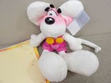 a stuffed mouse that is sitting next to a piece of paper