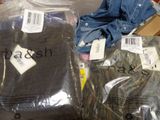 two bags of clothing that are sitting on a table